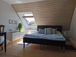 a bedroom with a bed with a wooden ceiling at Safine B&B in Fåborg