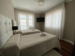 Postel nebo postele na pokoji v ubytování Villa OLYMPIA