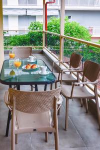 a table with a plate of food on a balcony at NikoleTakis Apartments in Paralia Panteleimonos