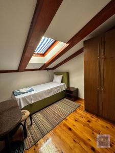 a bedroom with a bed and a skylight at Muo 33 Apartments in Kotor