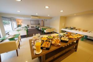 a table with food and drinks on it in a restaurant at Hotel Folgosa Douro in Armamar