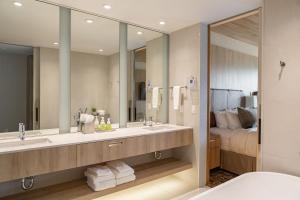 uma casa de banho com 2 lavatórios e um espelho grande em Headwaters Lodge at Eagle Ranch Resort em Invermere