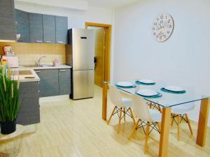 a kitchen with a table and chairs and a refrigerator at Casa Paty Fuerteventura in Puerto del Rosario