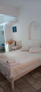 a bedroom with a large bed with a wooden frame at Dimitris Studios in Perissa