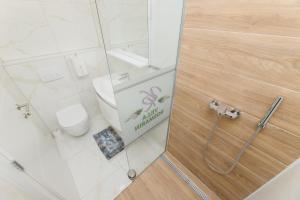 a bathroom with a toilet and a sign on the door at Villa Rosmarin - family friendly, beachfront in Pašman