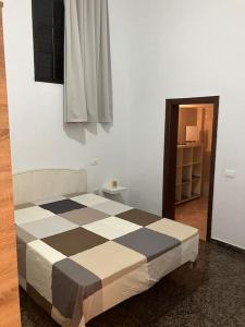 a bed in a room with a checkered floor at Apartamento en Gran Tarajal in Gran Tarajal