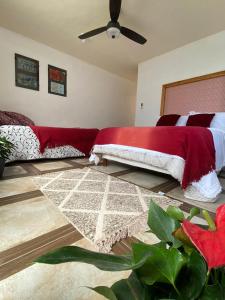 a bedroom with a bed with a red blanket at Casa Don Pancho in Cuernavaca