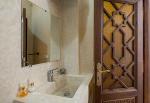 a bathroom with a sink and a mirror at Riad SULTANA in Tangier +37 photos