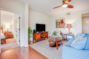 a living room with a blue couch and a tv at Pili Mai 1A in Koloa