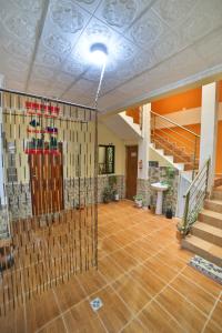 a large room with a staircase and a room with wooden floors at The Little House ApartHotel in Uyuni