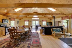 a kitchen and living room with a table and chairs at Bethel Chalet with Hot Tub 3 Miles to Sunday River! in Bethel