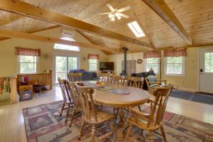 a dining room and living room with a table and chairs at Bethel Chalet with Hot Tub 3 Miles to Sunday River! in Bethel