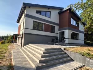 a house with stairs in front of it at Gackowo in Ostróda