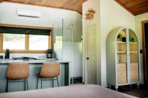 a kitchen with a counter and two bar stools at Lake with Dock and Hot Tub Hocking Hills Cabin in Rockbridge
