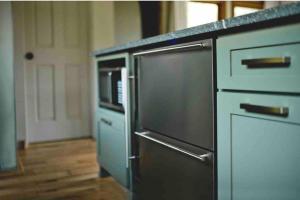 a kitchen with a stainless steel refrigerator and a microwave at Lake with Dock and Hot Tub Hocking Hills Cabin in Rockbridge +21 photos