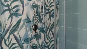 a shower with a glass door with a plant pattern at Oasi in centro - Cala Gonone in Cala Gonone +50 photos