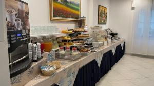 a buffet line with food and drinks on it at Hotel Gioiella in Rimini