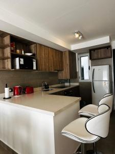 a kitchen with a counter and a refrigerator at Domum 144 2 in San Juan