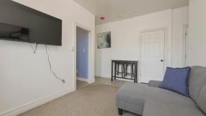 a living room with a couch and a tv at Atlantic Suite by the Boardwalk 2C in Atlantic City