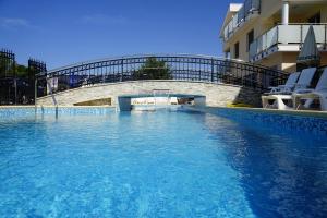 a swimming pool in front of a building at Funtana Villas an der 1 Reihe vom Meer in Funtana