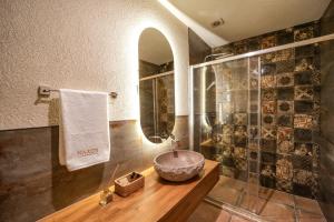 a bathroom with a bowl sink and a mirror at Naxos Beach Hotel in Marmaris