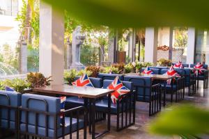 a row of tables and chairs with patriotic cushions on a patio at Ninh Bình Premier hotel in Ninh Binh