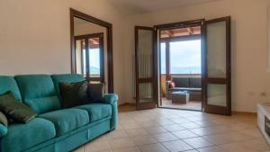 a living room with a blue couch and a mirror at La Terrazza In Centro Dorgali in Dorgali +59 photos