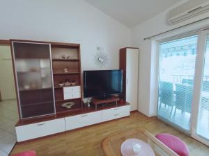 a living room with a television on a entertainment center at Apartment Anita in Umag +77 photos