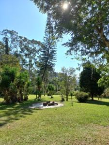 a park with trees and a field with grass at Sítio Toa Toa in São Roque