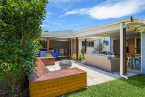 a home with a patio with a couch and a table at North Beach in Mylestom