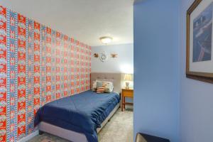 a bedroom with a blue bed and a wall covered in tiles at Home with Screened-In Porch Less Than 1 Mi to Lake Erie in Port Clinton