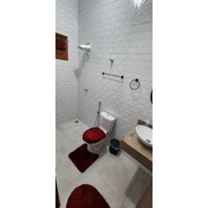 a bathroom with a toilet and a sink at Casa Nova temporada piscina aquecida 24hs in Olímpia
