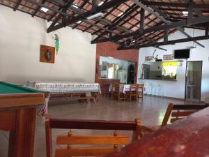 a living room with a pool table and chairs at Sítio Toa Toa in São Roque