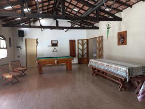 a room with a table and a pool table at Sítio Toa Toa in São Roque