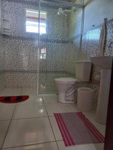 a bathroom with two toilets and a sink at Sítio Toa Toa in São Roque