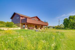 a barn with a field of grass and flowers at Prairie-Style Home on Garden Bay with Deck and Hot Tub in Garden