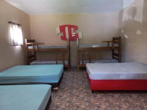 a room with three bunk beds in a room at Sítio Toa Toa in São Roque