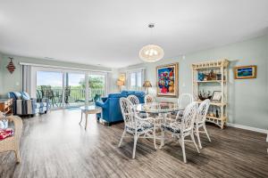 a living room with a table and chairs at Colony by the Sea #201 in Indian Beach