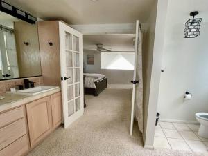 a bathroom with a door open to a bedroom at Beach House located in quiet community. in Oxnard