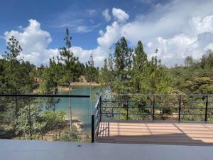 a balcony with a view of a body of water at Aqua Guatapé - Lakeside Luxury Villa in Guatapé
