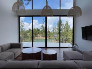 a living room with a couch and a table at Aqua Guatapé - Lakeside Luxury Villa in Guatapé