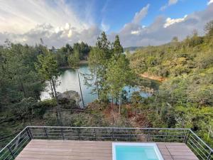 a view of a body of water from a boardwalk at Aqua Guatapé - Lakeside Luxury Villa in Guatapé