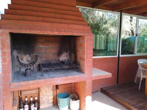 an outdoor brick fireplace with bottles of beer in it at Casa MERLITO - PISCINA DE USO EXCLUSIVO - HERMOSAS VISTAS A LAS SIERRAS -VILLA DE MERLO - SAN LUIS in Merlo