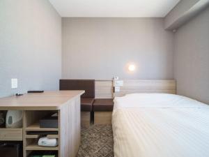 Postel nebo postele na pokoji v ubytování Super Hotel Shonan Fujisawaeki Minamiguchi