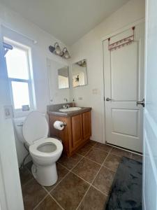 a bathroom with a toilet and a sink at Bodhi House, Joshua Tree National Park in Twentynine Palms