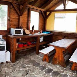 a kitchen with a table and a microwave in a cabin at Holiday home in Heviz - Balaton 44882 in Hévíz