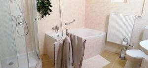 uma casa de banho com uma banheira, um chuveiro e um WC. em Apartment in Keszthely - Balaton 44884 em Keszthely