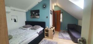 a bedroom with a bed and a couch at Holiday home in Keszthely - Balaton 44883 in Keszthely