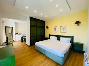 a bedroom with a large bed and a kitchen at VALE MAR Guest in Ribeira Brava