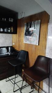 a kitchen with two chairs and a picture of a bike on the wall at La Toscana in Rocha